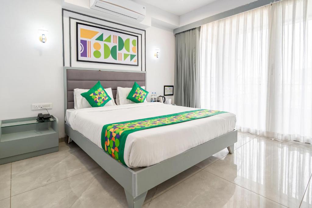 a bedroom with a large bed and a window at Treebo Arizona in Gandhinagar