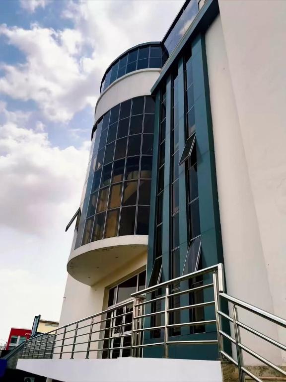 a building with a cross on the side of it at Chrisvirgy Hotels in Kubwa