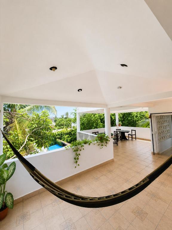 a hammock in the middle of a room with a patio at Casa Cultivo in Brisas de Zicatela