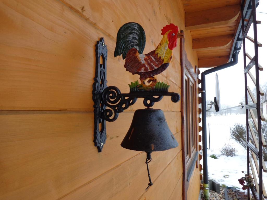 a bell on the side of a chicken coop at U Witalisa in Narewka