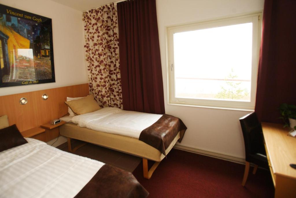 Postel nebo postele na pokoji v ubytování Hotell Höga Kusten