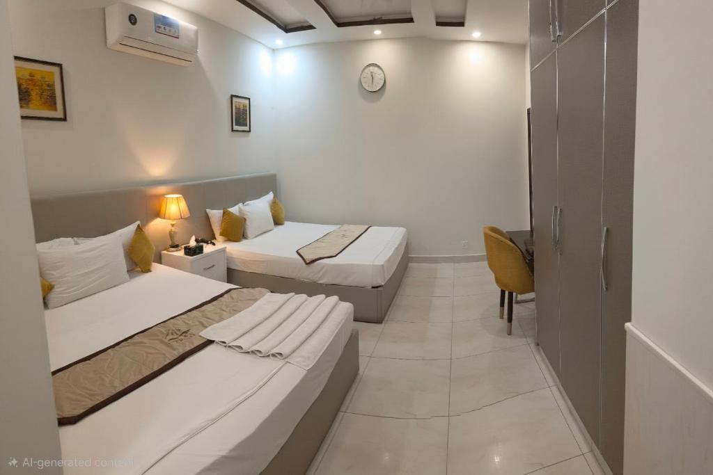 a room with two beds and a chair in it at Cuzzy Inn Stay in Lahore