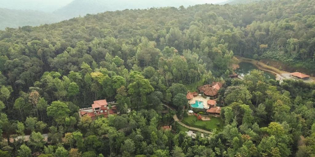 an aerial view of a house in the woods at Urvinkaan - An Estate Hotel Chikmagalur in Chikmagalur