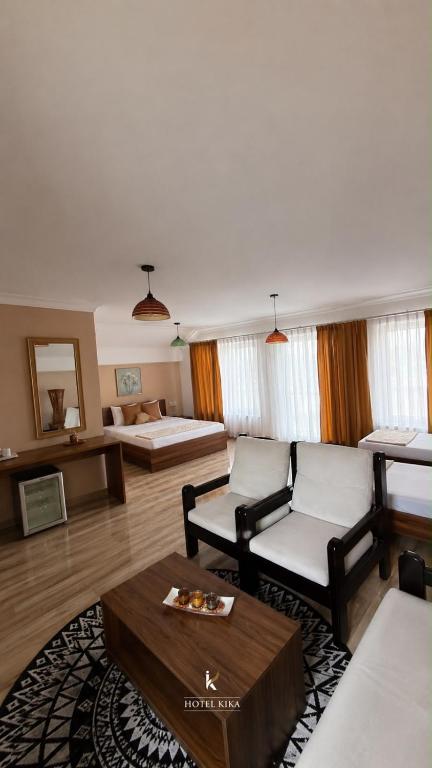 a living room with a couch and a table at Hotel Kika in Prishtinë