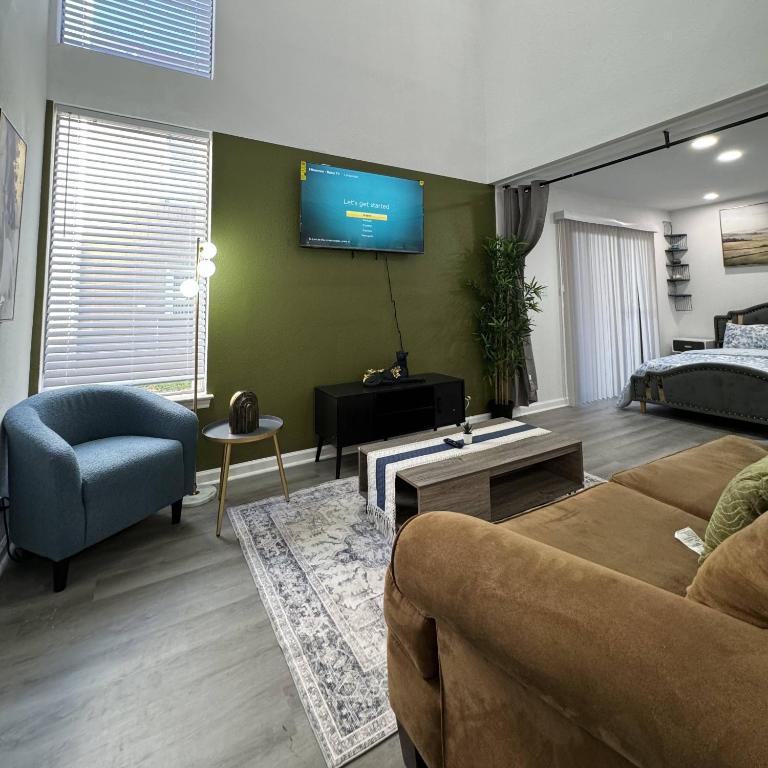 a living room with a couch and a tv on the wall at BR Dallas I6 in Dallas