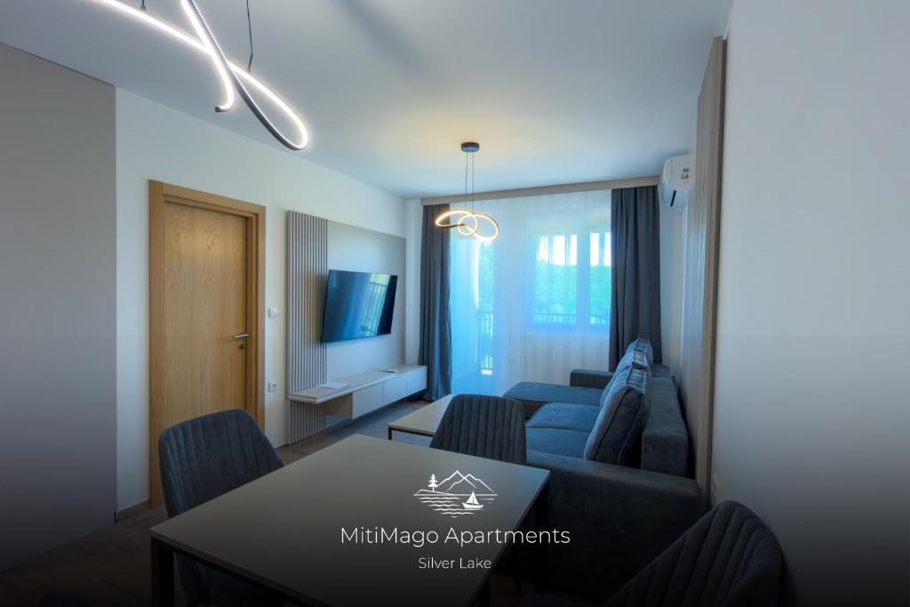 a living room with a couch and a table at Miti Apartment with Marina View & Spa Access in Veliko Gradište