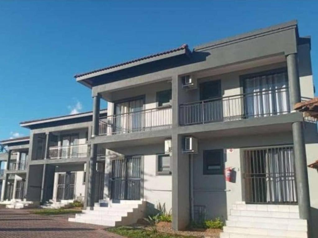an apartment building with balconies on the side of it at Matsamo Lakeview Lodge in Schoemansdal