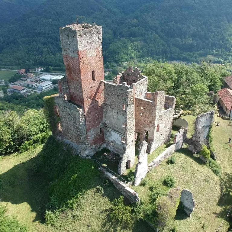 an old castle sitting on top of a field at Guest House Villa Castello in Nucetto