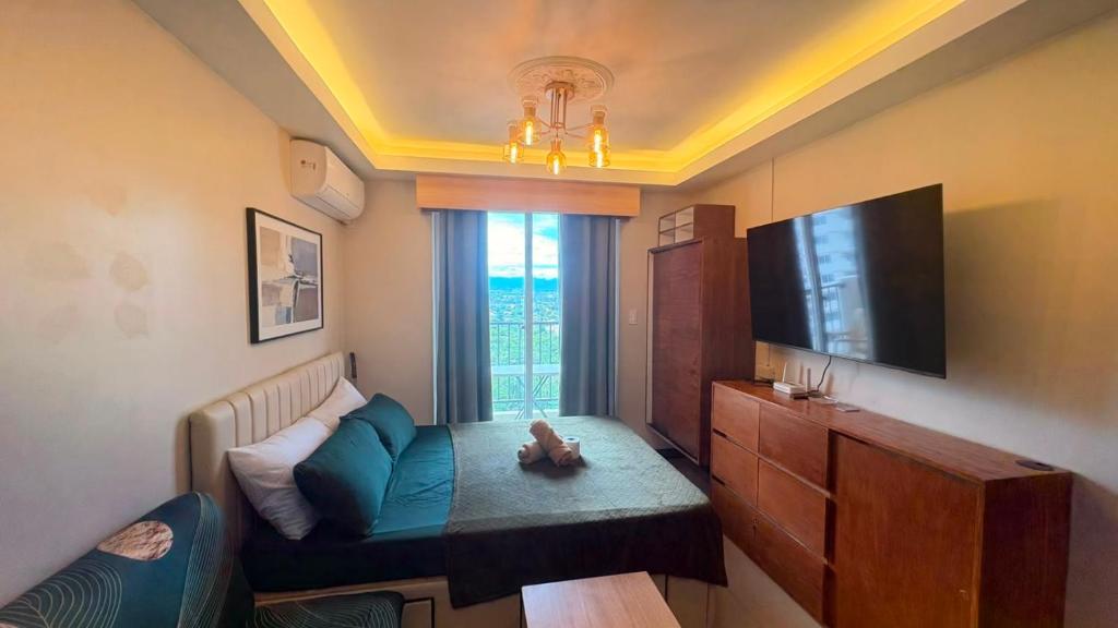 a small living room with a couch and a tv at 1403-304 Saekyung Pool view in Lapu Lapu City