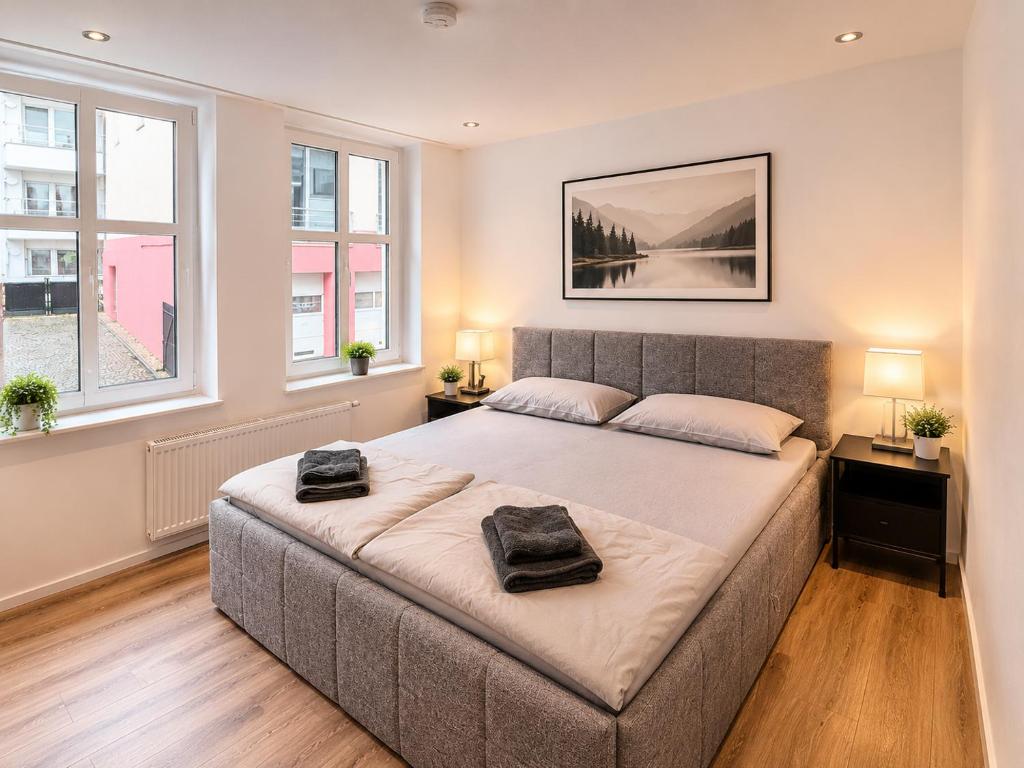 a bedroom with a large bed with two towels on it at PaderQuartier2 in Paderborn