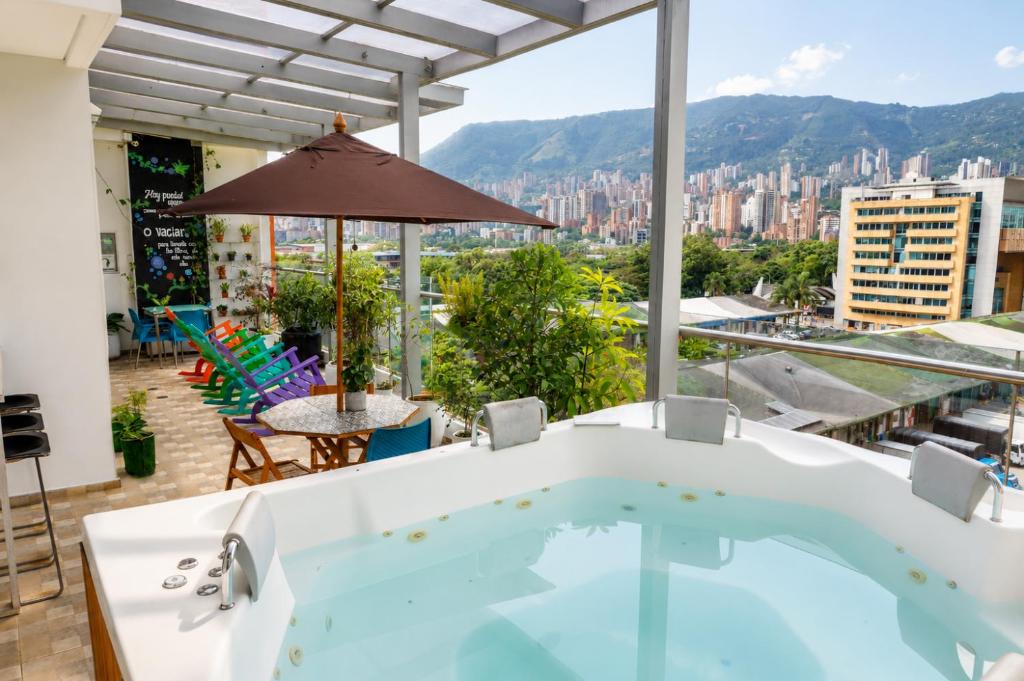 a hot tub on the roof of a building at Hotel Sixtina Plaza Medellin in Medellín