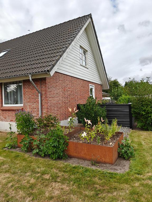 a house with a garden in the front yard at Skolevænget 35 in Skjern