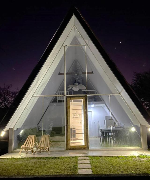 a church with two chairs and a door at night at Selah Cabaña de dos habitaciones in Villa Las Rosas