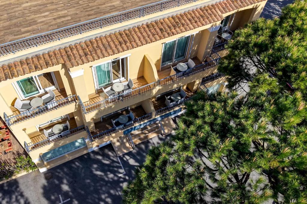 an overhead view of a hotel with a pool and trees at Le Petit Prince in Sainte-Maxime