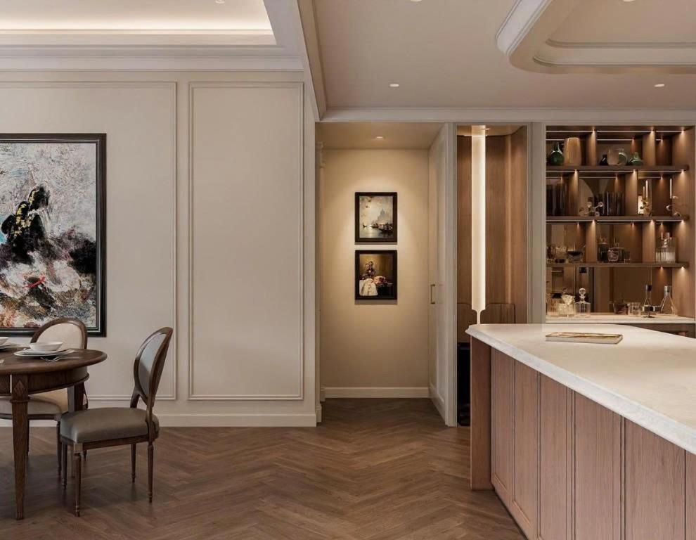 a kitchen with a bar and a table and chairs at Ben Thanh Luxury Hotel - Premium Kas Dilly & Spa in Ho Chi Minh City