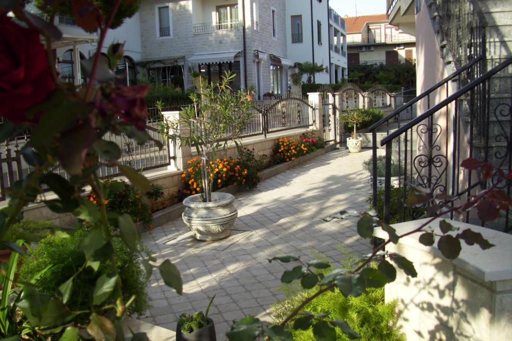 a patio with a fence and a potted plant at Apartments Josip Vodice in Vodice