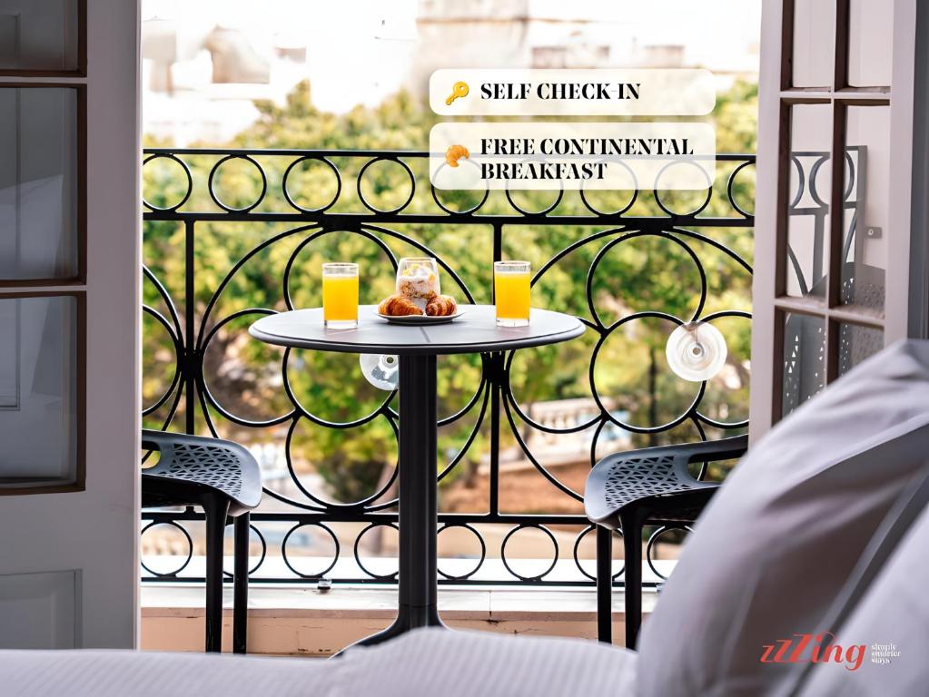 a table with a plate of food on a balcony at Yolanda Boutique Suites by Zzzing in Cospicua
