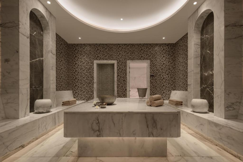 a lobby with a large table in the middle of a room at JAZ Elite Riviera in Port Ghalib