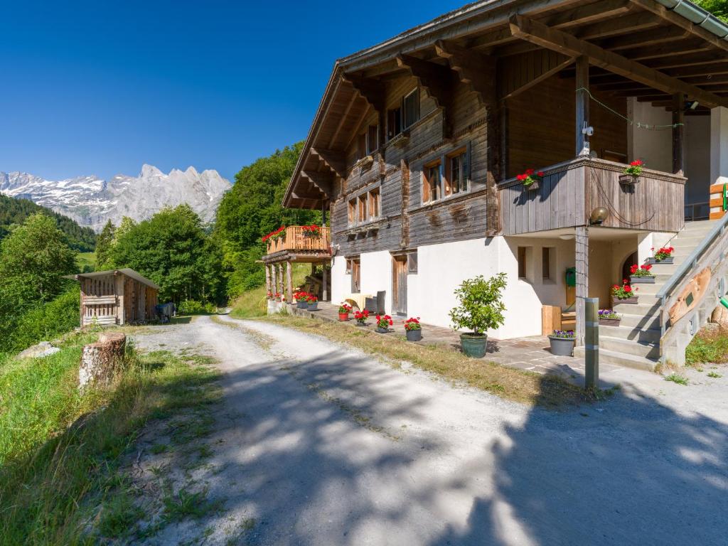 a house on a road next to a mountain at Gästehaus Milital in Innertkirchen