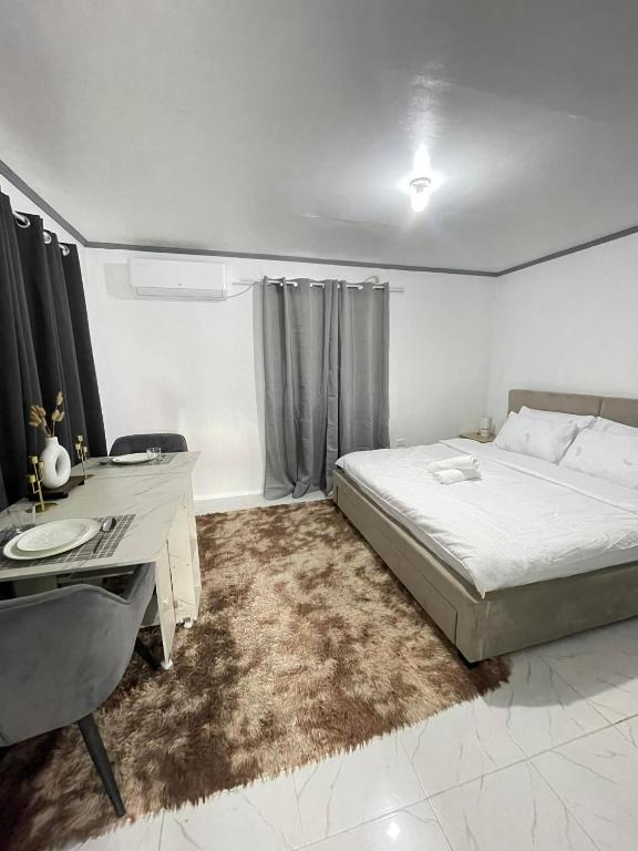 a white bedroom with a desk and a bed at CJ cozy tiny home in Santa Barbara