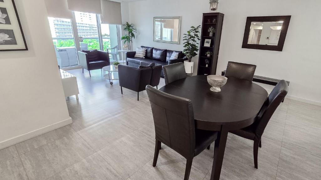 a dining room and living room with a table and chairs at THE TIDES 1 bedroom apt 8th floor WE ARE ON THE BEACH in Hollywood