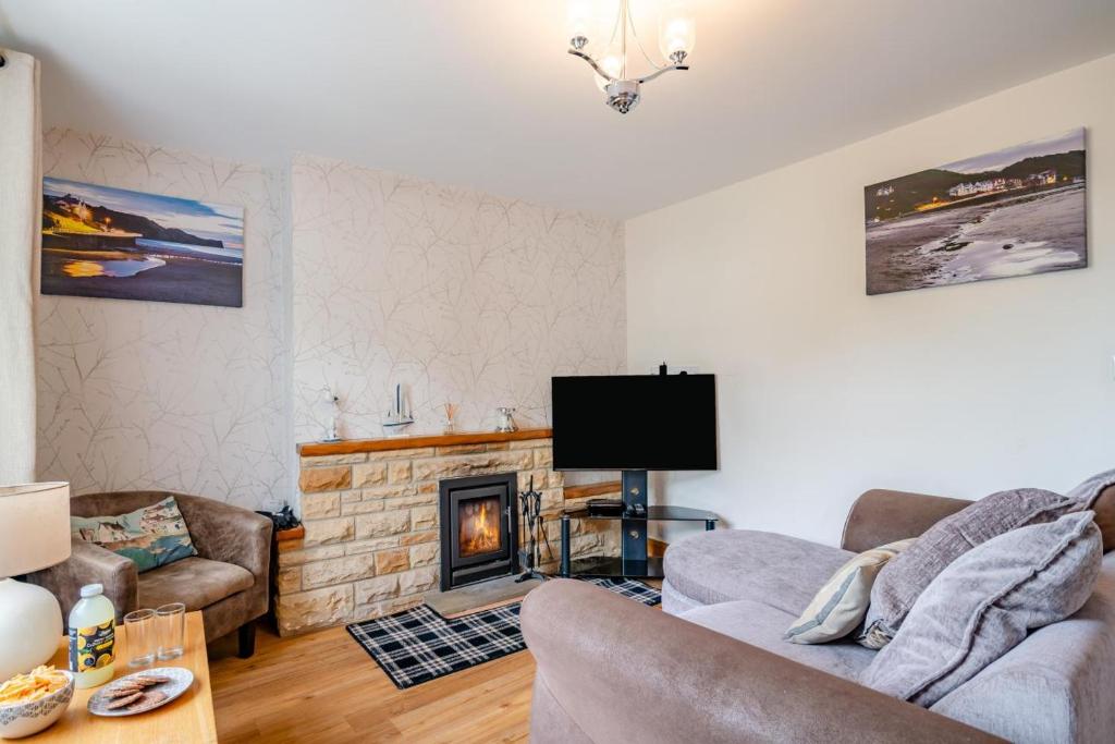 a living room with a couch and a fireplace at 3 Bed in Sandsend oc-wa081 in Sandsend