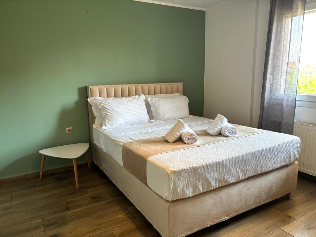 a bed with two pillows on it in a bedroom at Boho House Florina in Florina