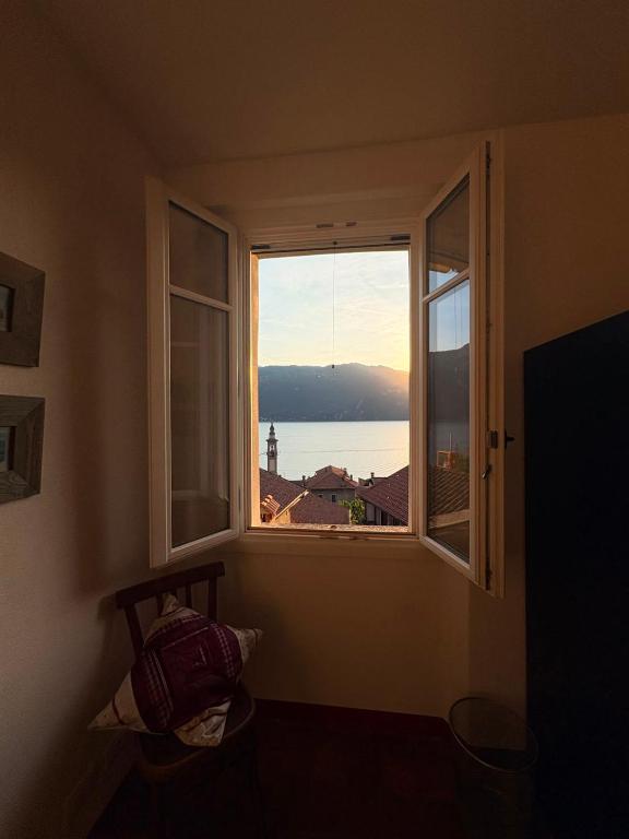 a window in a room with a view of the ocean at Olcium Holiday Rooms in Mandello del Lario