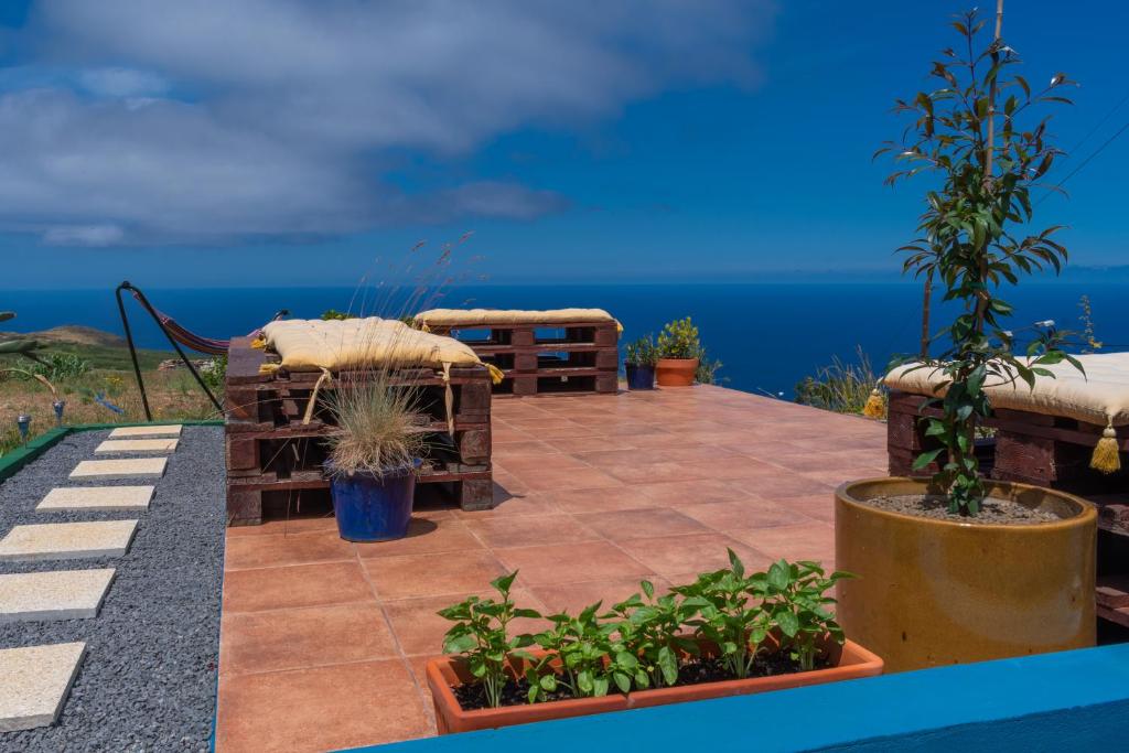 a patio with a view of the ocean at This Old House in Ponta do Pargo