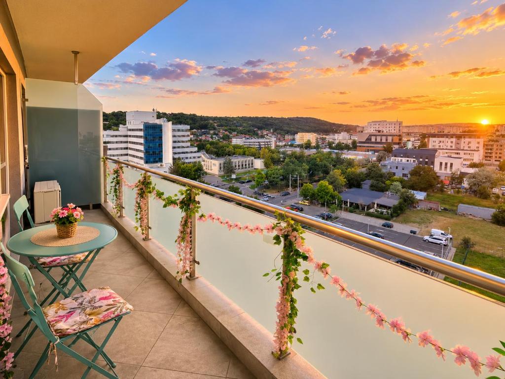a balcony with a table and a view of a city at CENTRAL Apartment 84- free parking- spital Recuperare in Iaşi