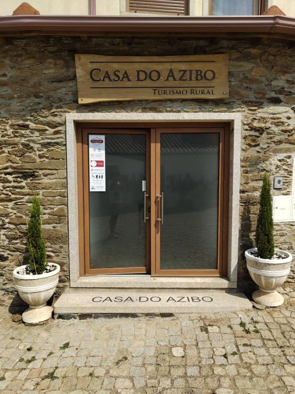 a entrance to a building with a glass door at Casa do Azibo in Santa Combinha