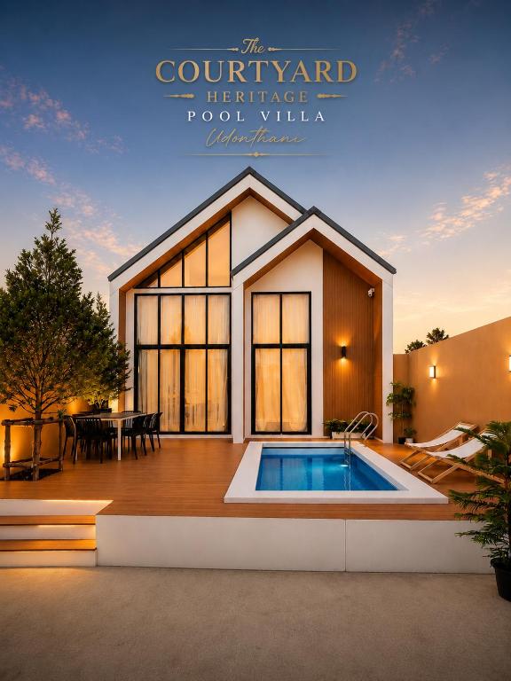 a villa with a swimming pool in front of a house at The Courtyard Heritage Pool Villa Udonthani in Udon Thani