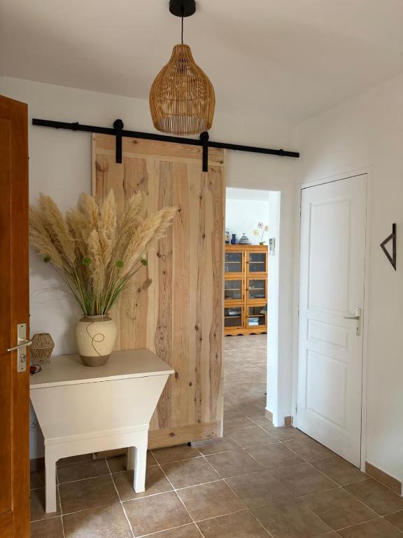 a room with a wooden door and a vase on a table at A Casa POGGIOLI in Rogliano