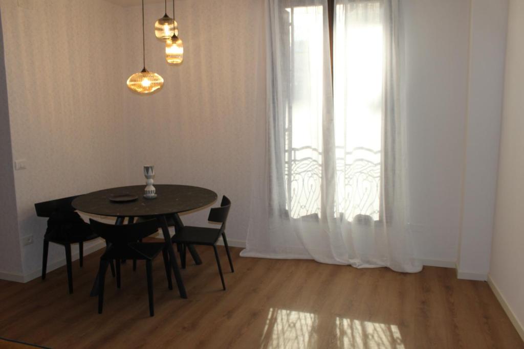 a dining room with a table and chairs and a window at Bonbon in Treviso