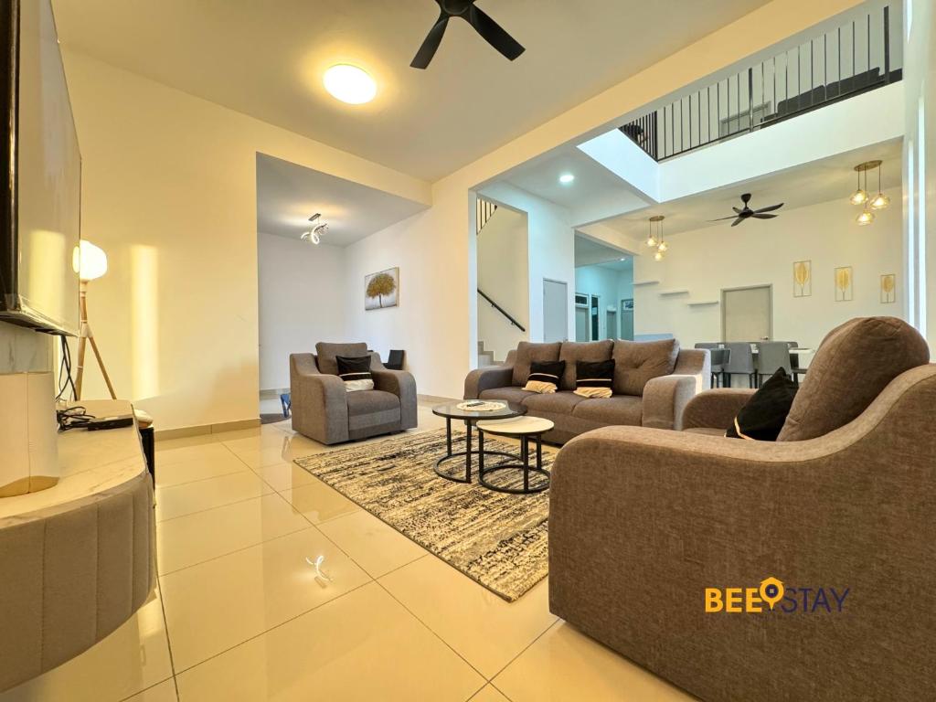 a living room with two couches and a table at Desaru Arcadia Double Storey House 11-16 Pax 5 Mins to Desaru Beach in Bandar Penawar