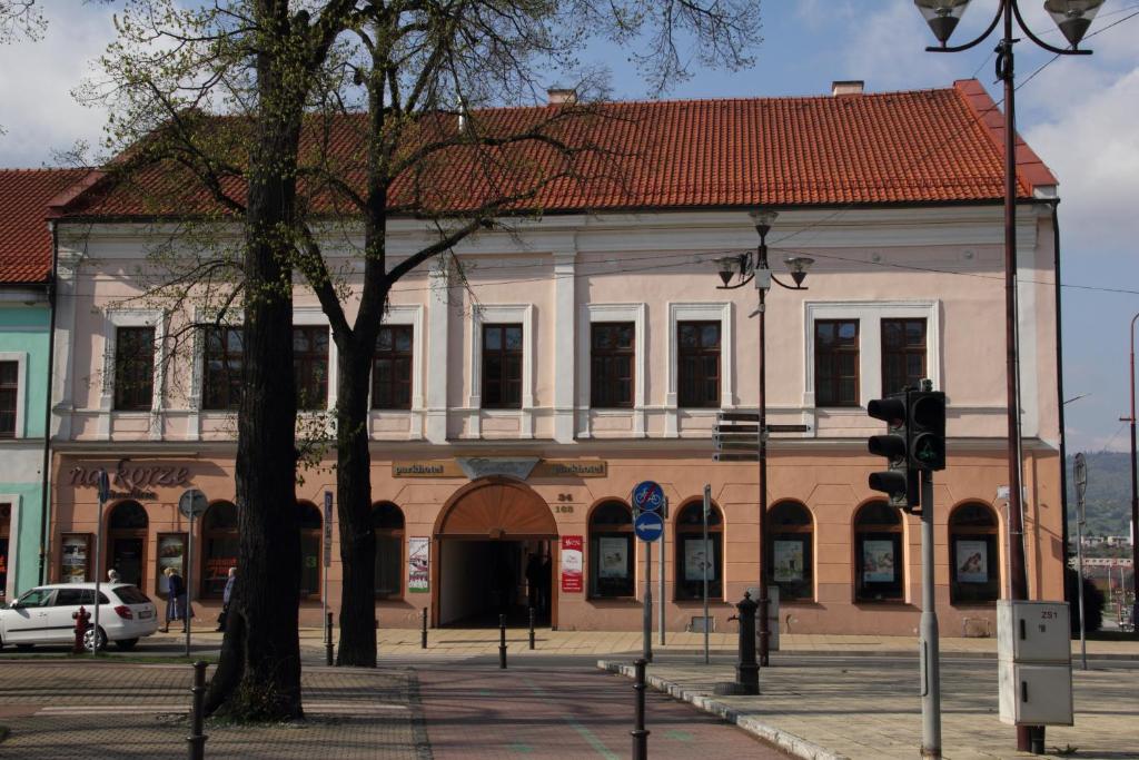 a large building with a red roof on a street at Parkhotel Centrum in Spišská Nová Ves