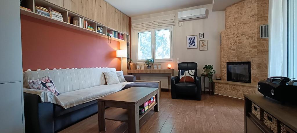a living room with a couch and a table at Country Nest in Messini