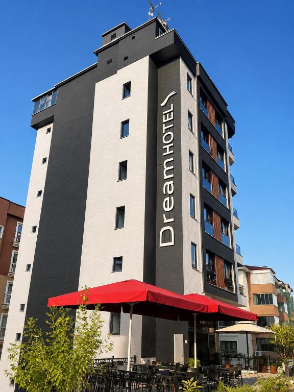 a tall building with a red umbrella in front of it at Dream Hotel in Trabzon