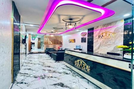a bar with purple lights in a restaurant at Standard Elite Palace inn Hotel in Islamabad