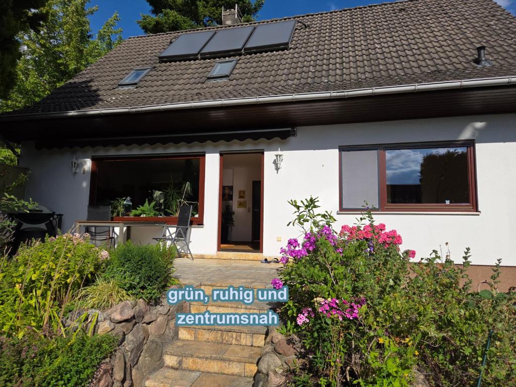 a house with solar panels on the roof at 4 Sterne Souterrain Apartment Alt-Mariendorf in Berlin