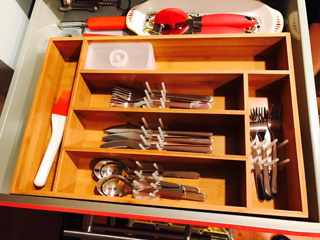 a wooden drawer with utensils in it at Studio H St Corridor in Washington