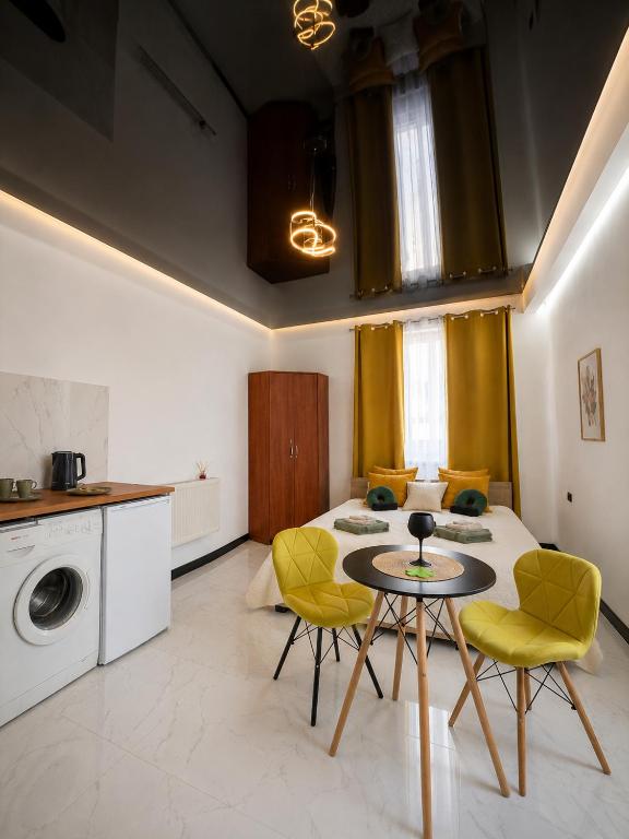 a room with a bed and a table and chairs at Powidz Comfort Suites in Powidz