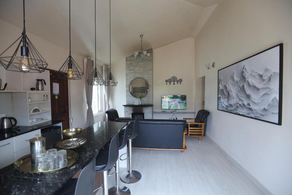 a kitchen and dining room with a table and chairs at Two Seas Residence - Boutique Residences in Ooty
