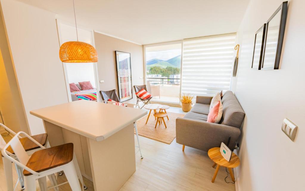 a living room with a couch and a table at Oceana Suites Papudo in Papudo