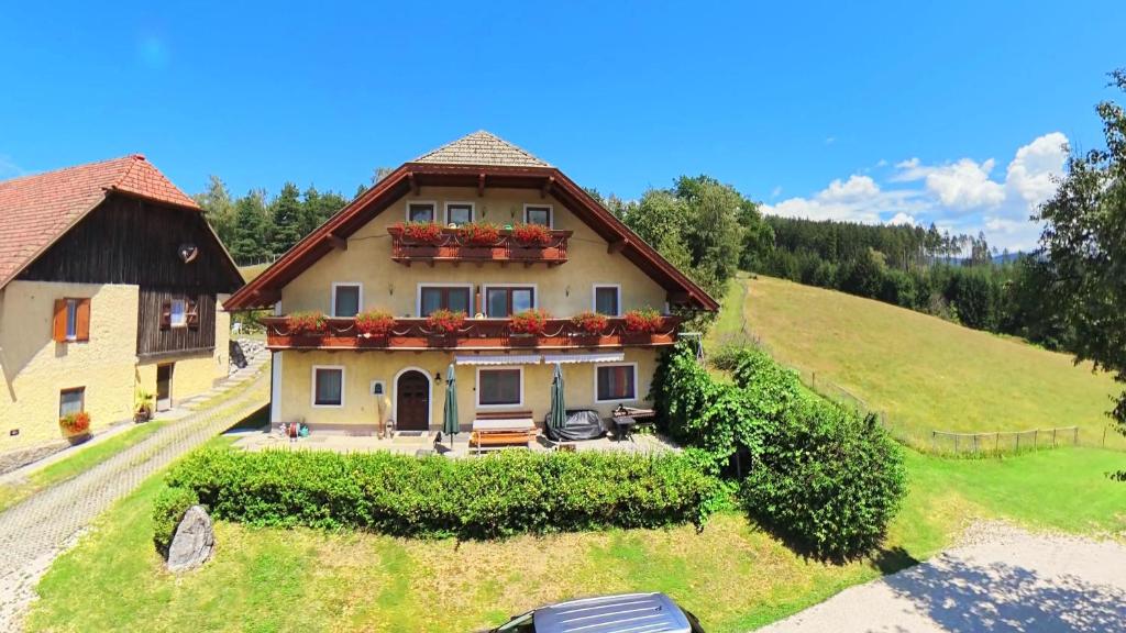 a house on a hill with flowers on it at Ferienhaus Huber in Bleiburg