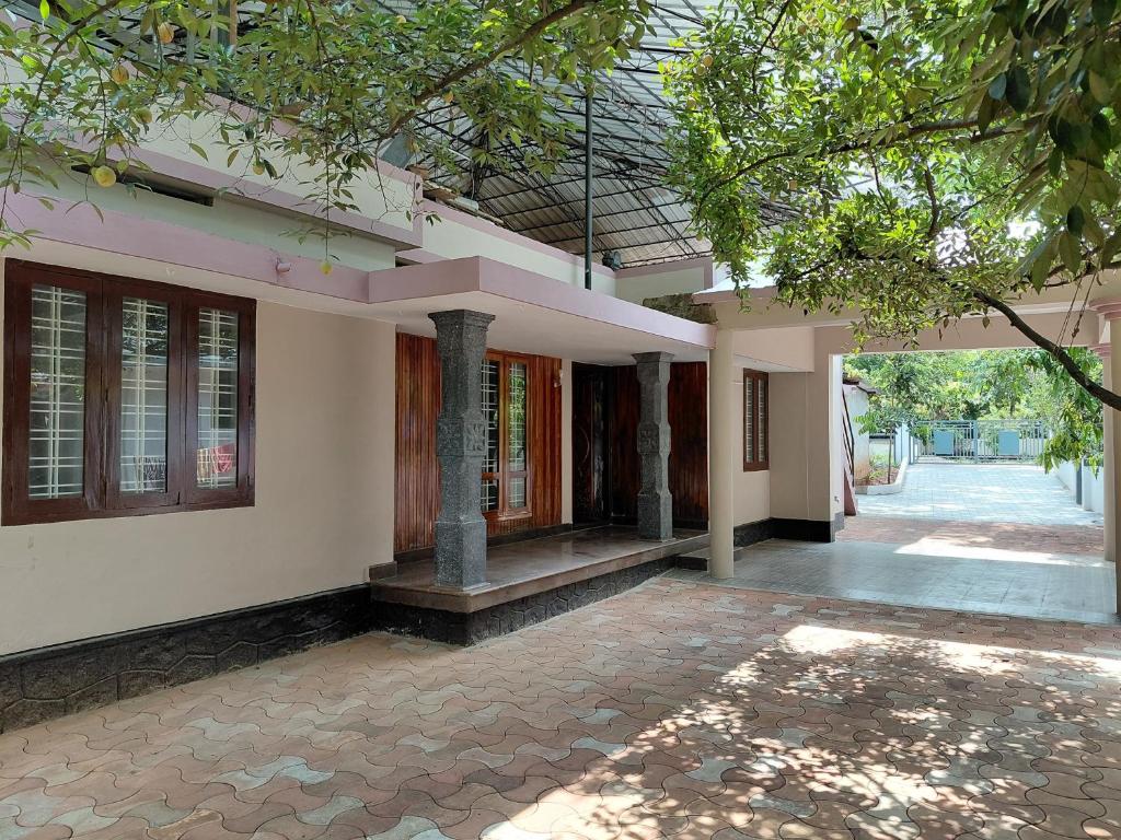 a house with a courtyard with a building at Casa Inn Homestay in Munnar