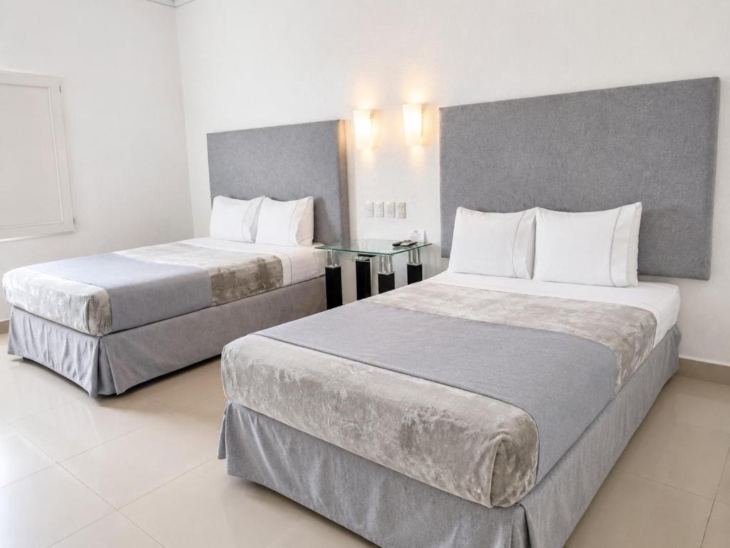 zwei Betten in einem Hotelzimmer mit zwei Betten in der Unterkunft Zar Culiacan in Culiacán Rosales