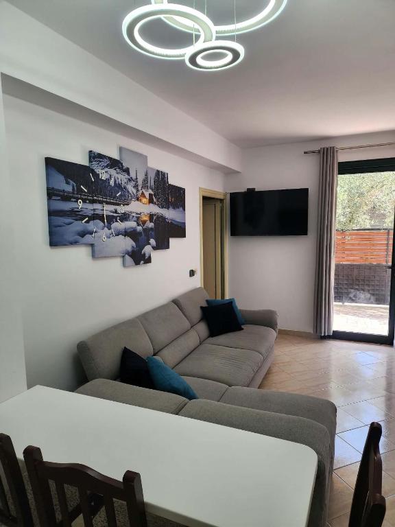 a living room with a couch and a tv at Apartment 1 by Villa Ceni in Elbasan