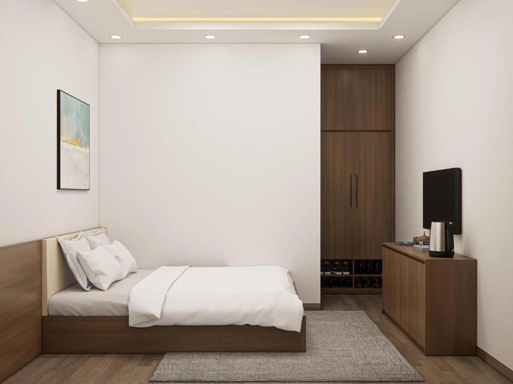 a bedroom with a bed and a flat screen tv at Eco House Cat Ba in Hai Phong