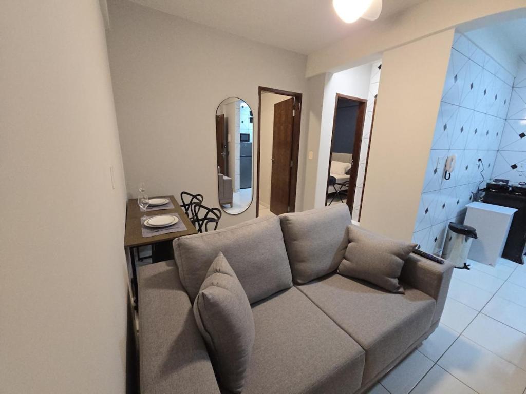 a living room with a couch and a table at Apto com 2 quartos e A/C no Centro in Montes Claros